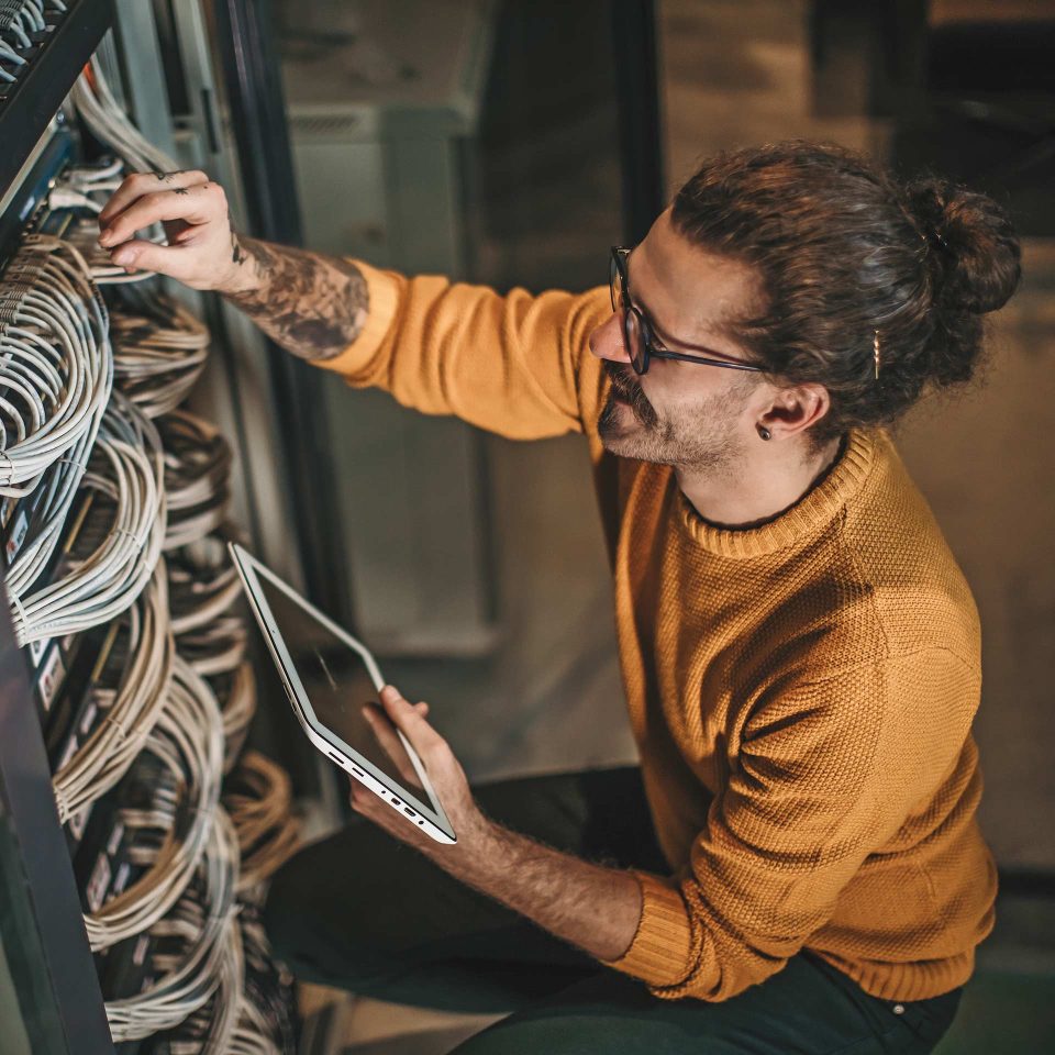 IT professional working on network cabling