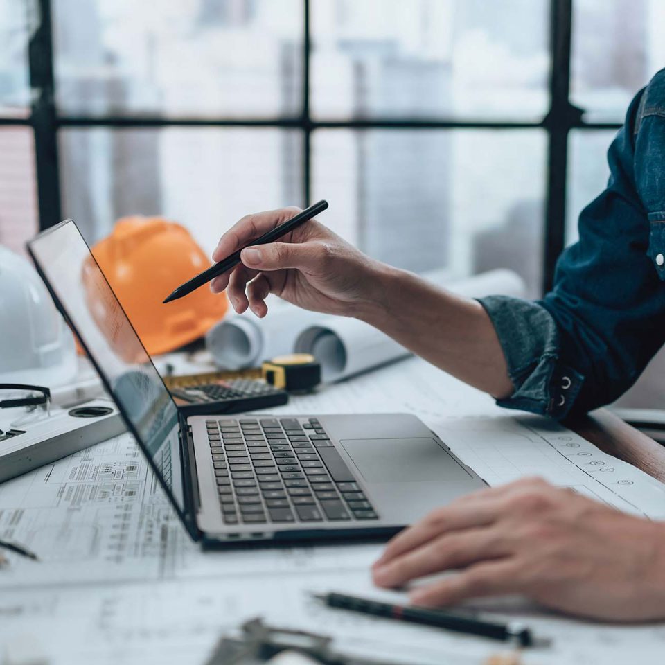 Information technology designer working with drawings at a desk