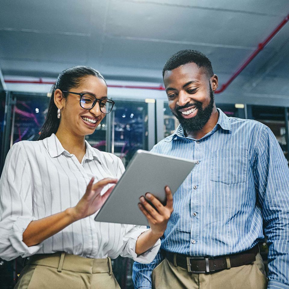 two young IT technicians review flexible it solutions on a digital tablet