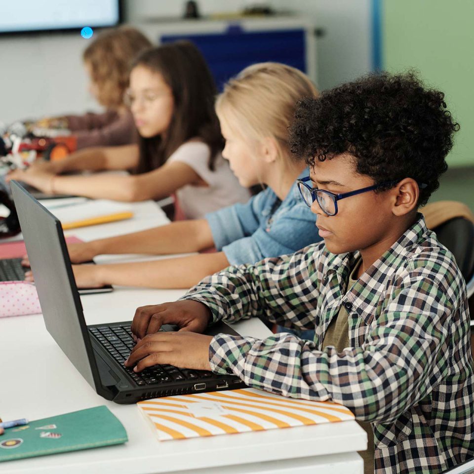 students working at laptops while using school's wireless network